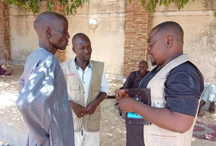 Three people speaking outdoors