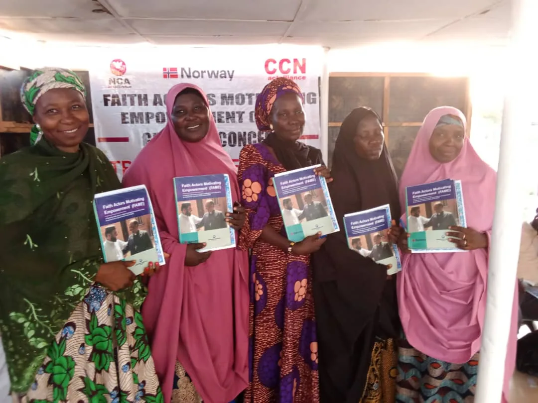 Participants holding printed materials