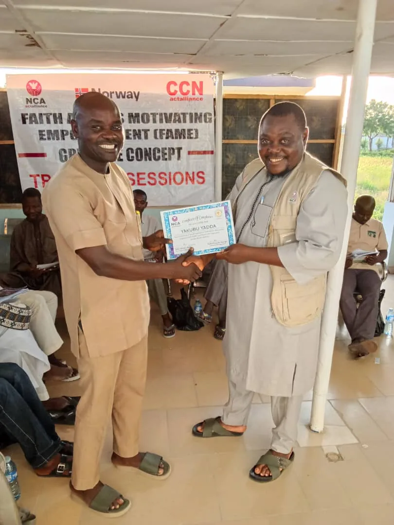Two people holding a certificate