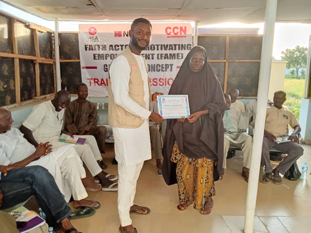 Two people presenting a certificate